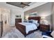 A view of the main bedroom with a wooden bed frame, neutral walls, and tiled flooring at 14436 Ponce De Leon Trl, Port Charlotte, FL 33981