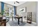 Bright office space with a large window, a desk, an accent chair, and shelving at 14436 Ponce De Leon Trl, Port Charlotte, FL 33981