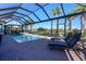 The screened-in pool is a perfect spot to unwind and soak up the sun with lounge seating at 14436 Ponce De Leon Trl, Port Charlotte, FL 33981