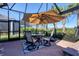 Great outdoor living, this screened-in pool area has a shaded table and comfortable seating at 14436 Ponce De Leon Trl, Port Charlotte, FL 33981