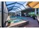 Gorgeous screened-in pool and spa offer a private oasis with a covered lanai at 14436 Ponce De Leon Trl, Port Charlotte, FL 33981