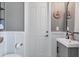 Charming powder room with wainscoting, a modern vanity, and unique decor at 14436 Ponce De Leon Trl, Port Charlotte, FL 33981