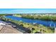 Scenic waterfront view with backyard access, docks, and tropical landscaping in a desirable neighborhood at 14436 Ponce De Leon Trl, Port Charlotte, FL 33981