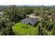 Areal view showcasing the home with lush green landscape and surrounding mature trees at 17156 Eugene Ave, Port Charlotte, FL 33954