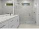 Beautiful bathroom featuring stylish marble tile, frameless glass shower, and vanity with stone countertop at 17156 Eugene Ave, Port Charlotte, FL 33954