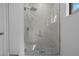 Bathroom showcasing tiled shower with glass door and rainfall shower head at 17156 Eugene Ave, Port Charlotte, FL 33954