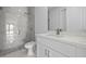 Modern bathroom featuring tiled shower, toilet, vanity and cabinet with countertop at 17156 Eugene Ave, Port Charlotte, FL 33954