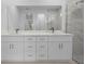 Bathroom featuring double vanity and tiled shower with glass door at 17156 Eugene Ave, Port Charlotte, FL 33954