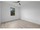 Simple bedroom features a modern ceiling fan and a well-lit window at 17156 Eugene Ave, Port Charlotte, FL 33954