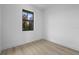 Bright bedroom features a window with view and light wood-look flooring at 17156 Eugene Ave, Port Charlotte, FL 33954