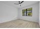 Light-filled bedroom with ceiling fan and a view from the window at 17156 Eugene Ave, Port Charlotte, FL 33954