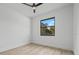 Minimalist bedroom with a view of the outdoors through a large window at 17156 Eugene Ave, Port Charlotte, FL 33954