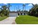 Charming single-story home featuring a two-car garage, well-maintained lawn, and inviting curb appeal at 17156 Eugene Ave, Port Charlotte, FL 33954
