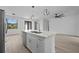 Open-concept kitchen island features a stainless steel sink and stylish pendant lighting at 17156 Eugene Ave, Port Charlotte, FL 33954