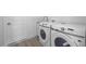 Laundry area with modern washer and dryer units and nearby door at 17156 Eugene Ave, Port Charlotte, FL 33954