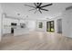 Open-concept living area with kitchen, dining, and living spaces featuring wood-look floors at 17156 Eugene Ave, Port Charlotte, FL 33954
