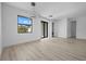 Open-concept living space with wood-look flooring, contemporary lighting, a double door and access to the laundry room at 17156 Eugene Ave, Port Charlotte, FL 33954