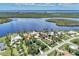 Waterfront community featuring luxurious homes, serene water views, and lush green landscaping from an aerial perspective at 17509 Ohara Dr, Port Charlotte, FL 33948