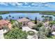 Stunning waterfront home with lush landscaping, circular driveway, and beautiful tile roof at 17509 Ohara Dr, Port Charlotte, FL 33948