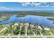 Expansive aerial shot of waterfront estates, showcasing prime location and breathtaking views of the bay at 17509 Ohara Dr, Port Charlotte, FL 33948
