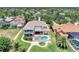 Aerial view of waterfront home featuring a backyard pool, patio, private boat dock and mature landscaping at 17509 Ohara Dr, Port Charlotte, FL 33948