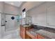 Bright bathroom with a glass-enclosed shower, granite countertops, and modern fixtures at 17509 Ohara Dr, Port Charlotte, FL 33948