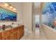 Bathroom featuring dolphin artwork, a marble sink, and tiled floors at 17509 Ohara Dr, Port Charlotte, FL 33948