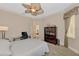 Well-lit bedroom featuring ceiling fan, carpet, and wooden bookcase at 17509 Ohara Dr, Port Charlotte, FL 33948