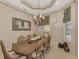 Bright dining room with large table and decorative ceiling at 17509 Ohara Dr, Port Charlotte, FL 33948