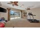 Spacious exercise room with treadmill, gym equipment, and sliding doors to the balcony at 17509 Ohara Dr, Port Charlotte, FL 33948