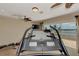 Exercise room showcasing a treadmill with waterfront views, a ceiling fan and natural light at 17509 Ohara Dr, Port Charlotte, FL 33948