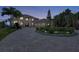 Elegant home with a circular driveway, fountain, meticulous landscaping, and a three-car garage at 17509 Ohara Dr, Port Charlotte, FL 33948