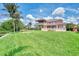 An expansive backyard with lush landscaping leads up to this beautiful waterfront home at 17509 Ohara Dr, Port Charlotte, FL 33948