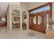 Elegant foyer with marble floors, grand entrance door, and view of dining area at 17509 Ohara Dr, Port Charlotte, FL 33948