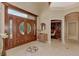 Bright foyer with double doors, tiled floors, and view of an office at 17509 Ohara Dr, Port Charlotte, FL 33948