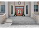 Grand entryway with double wooden doors, sidelights, and decorative stonework at 17509 Ohara Dr, Port Charlotte, FL 33948