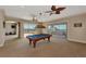 Bright game room with pool table, opening to a large patio with water views at 17509 Ohara Dr, Port Charlotte, FL 33948