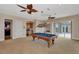 Large game room with pool table, wet bar, multiple ceiling fans, and access to outdoor patio at 17509 Ohara Dr, Port Charlotte, FL 33948