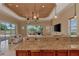 Kitchen island with a bar top overlooking the living room, pool, and waterfront views at 17509 Ohara Dr, Port Charlotte, FL 33948