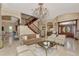 Bright living room with high ceilings, a fireplace, and an elegant staircase at 17509 Ohara Dr, Port Charlotte, FL 33948