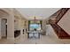 Spacious living room featuring a fireplace, staircase, and water views at 17509 Ohara Dr, Port Charlotte, FL 33948