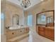 The main bathroom boasts a standalone tub, tile backsplash, dual sinks, and a chandelier at 17509 Ohara Dr, Port Charlotte, FL 33948