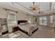Large main bedroom with trey ceilings, carpet floors, and views of the water at 17509 Ohara Dr, Port Charlotte, FL 33948