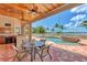 Covered patio with outdoor dining area, pool, and waterfront views at 17509 Ohara Dr, Port Charlotte, FL 33948