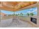 Tile patio with a fireplace, hammock, wood ceiling, and beautiful waterfront views at 17509 Ohara Dr, Port Charlotte, FL 33948