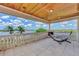 Wide patio featuring stone floors, a fireplace, wood ceiling, and waterfront views at 17509 Ohara Dr, Port Charlotte, FL 33948
