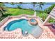 A luxurious pool and spa with brick tile, offering a private outdoor oasis at 17509 Ohara Dr, Port Charlotte, FL 33948