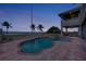 Twilight shot of waterfront pool and spa in backyard with covered patio at 17509 Ohara Dr, Port Charlotte, FL 33948