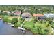 Beautiful waterfront property with a private dock, lush lawn, and a sparkling pool, ideal for outdoor entertaining at 17509 Ohara Dr, Port Charlotte, FL 33948