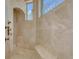 Elegant shower with marble tiling, a built-in bench, and decorative window at 17509 Ohara Dr, Port Charlotte, FL 33948